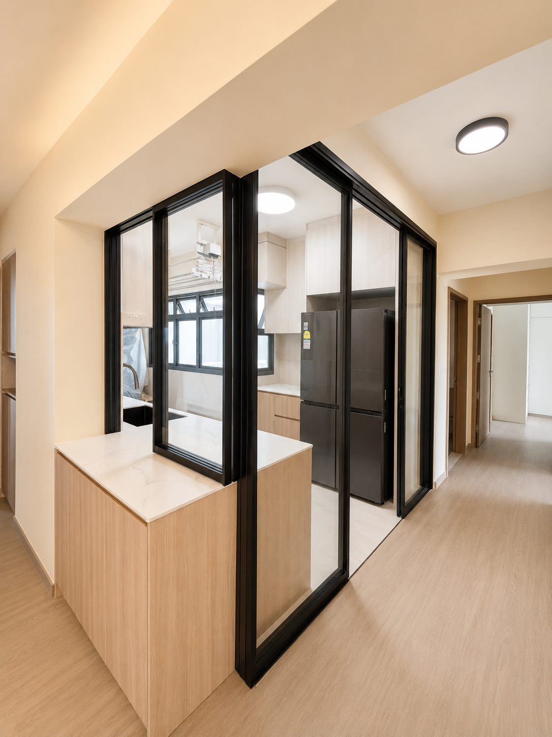 Black-framed glass door zoning a Tengah flat